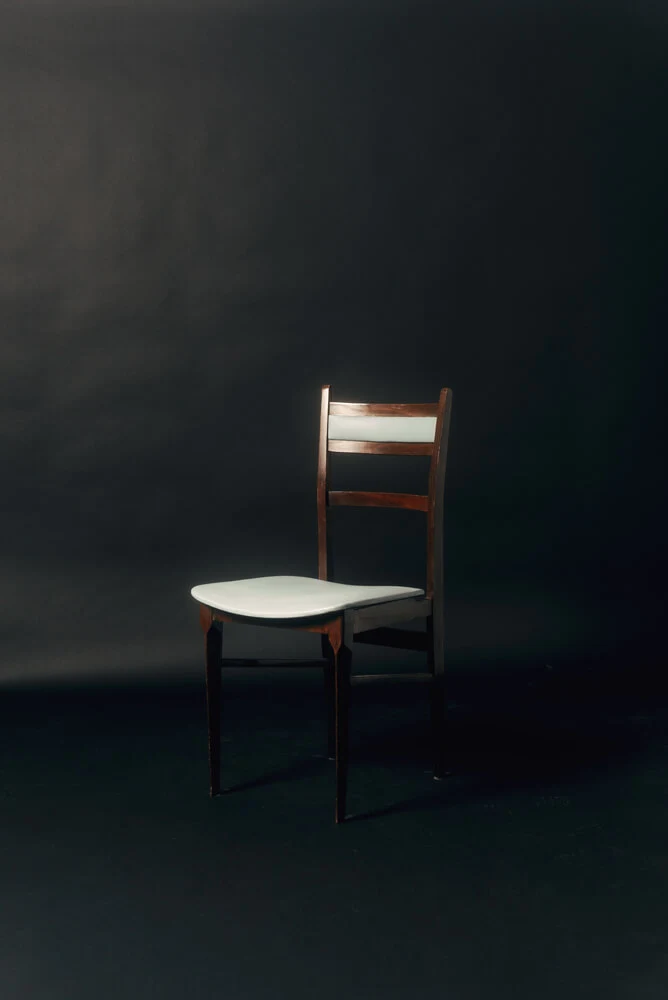 a vintage chair in a black stage